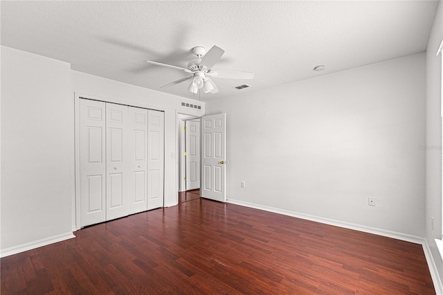 unfurnished bedroom featuring baseboards, visible vents, and wood finished floors