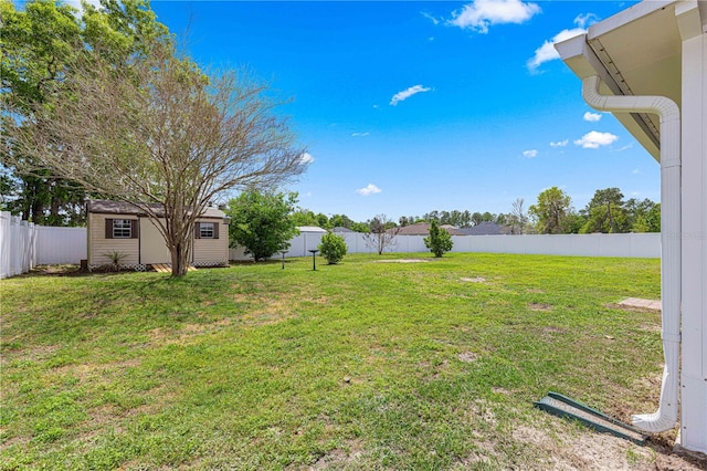 view of yard with a fenced backyard and an outdoor structure