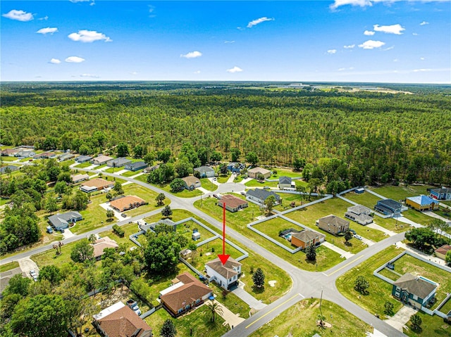 drone / aerial view with a view of trees and a residential view