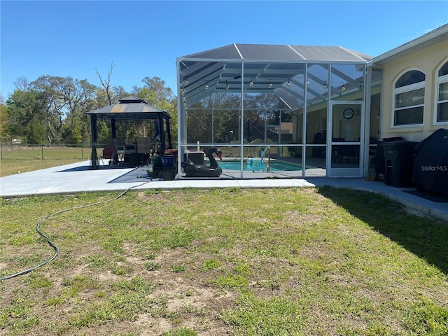 5323 SW 111th Lane Rd, Ocala, FL 34476 - view of grassy yard with a gazebo, a patio, an outdoor pool, and a lanai