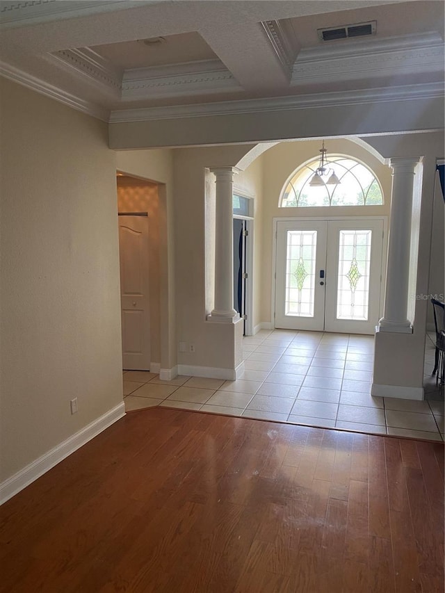 5323 SW 111th Lane Rd, Ocala, FL 34476 - foyer entrance featuring decorative columns, light wood-style floors, crown molding, arched walkways, and french doors