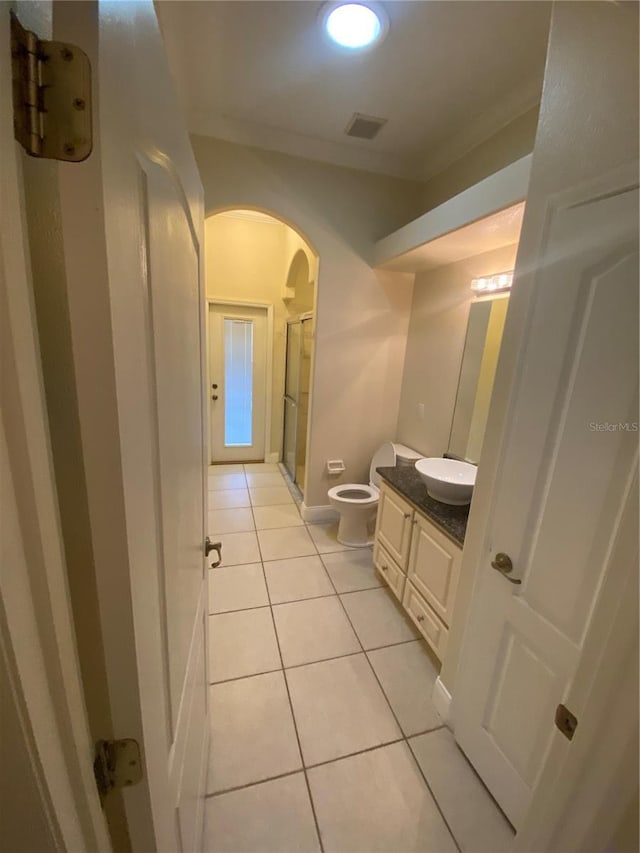 5323 SW 111th Lane Rd, Ocala, FL 34476 - bathroom featuring vanity, a shower stall, toilet, tile patterned floors, and ornamental molding
