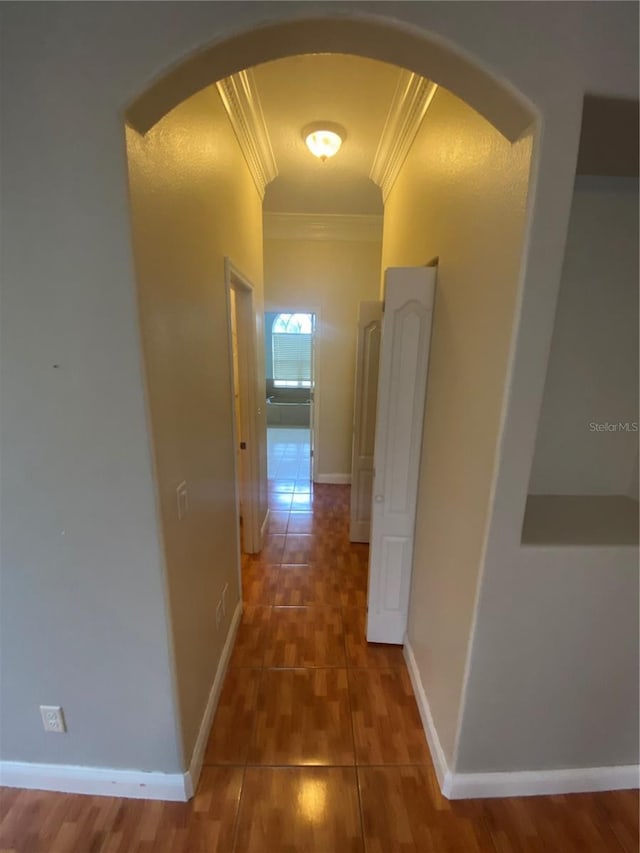 5323 SW 111th Lane Rd, Ocala, FL 34476 - corridor with crown molding, arched walkways, tile patterned flooring, and baseboards