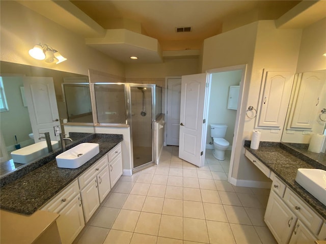 5323 SW 111th Lane Rd, Ocala, FL 34476 - bathroom featuring toilet, tile patterned floors, two vanities, and a shower stall