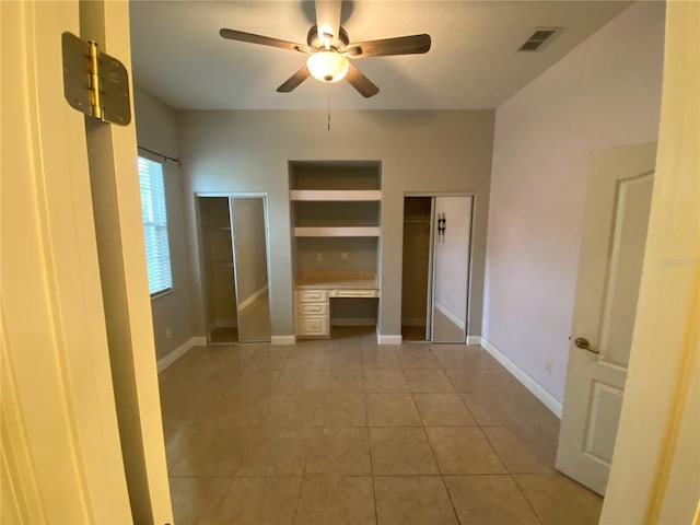 5323 SW 111th Lane Rd, Ocala, FL 34476 - unfurnished bedroom featuring light tile patterned flooring, two closets, baseboards, and ceiling fan