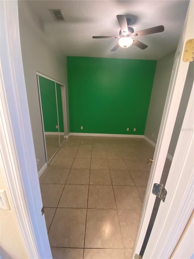 5323 SW 111th Lane Rd, Ocala, FL 34476 - empty room featuring tile patterned floors, ceiling fan, a textured ceiling, and baseboards