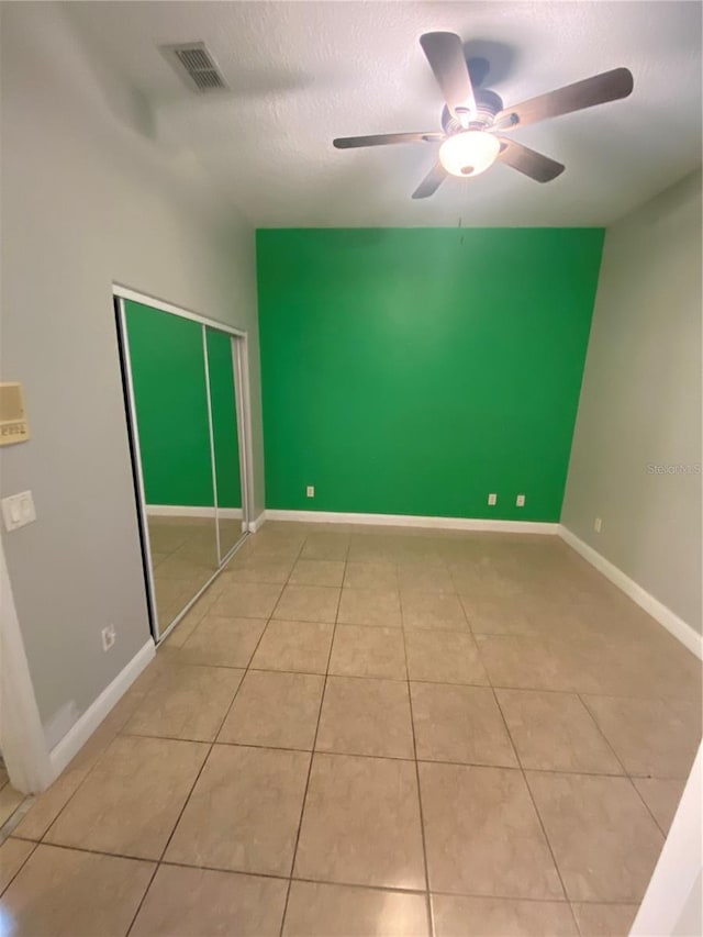 5323 SW 111th Lane Rd, Ocala, FL 34476 - tiled empty room with a textured ceiling, a ceiling fan, and baseboards