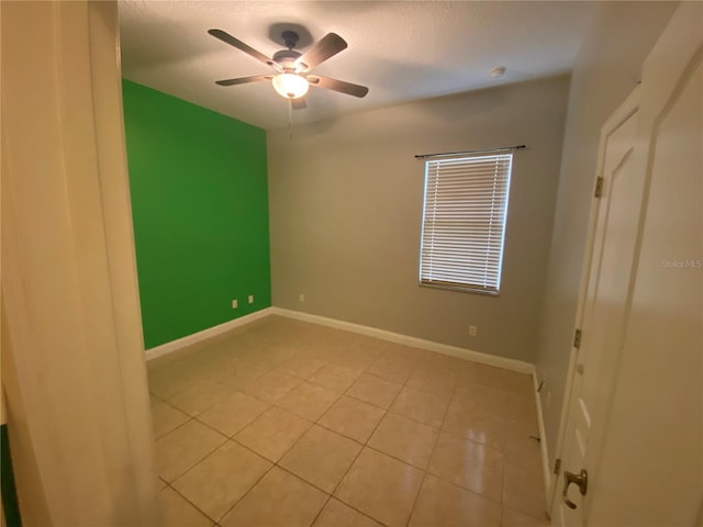 5323 SW 111th Lane Rd, Ocala, FL 34476 - unfurnished bedroom with light tile patterned floors, ceiling fan, baseboards, and a textured ceiling