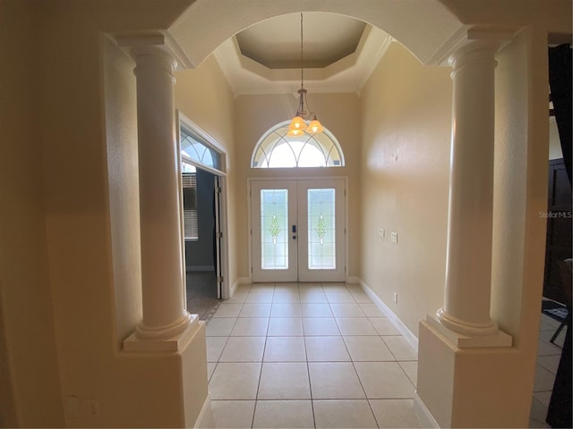 5323 SW 111th Lane Rd, Ocala, FL 34476 - foyer entrance with ornate columns, french doors, light tile patterned flooring, arched walkways, and ornamental molding