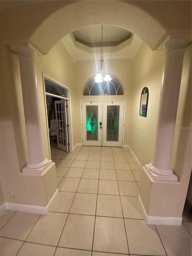 5323 SW 111th Lane Rd, Ocala, FL 34476 - foyer entrance with ornate columns, arched walkways, a tray ceiling, and french doors