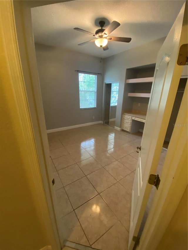 5323 SW 111th Lane Rd, Ocala, FL 34476 - spare room featuring light tile patterned floors, ceiling fan, baseboards, and a textured ceiling