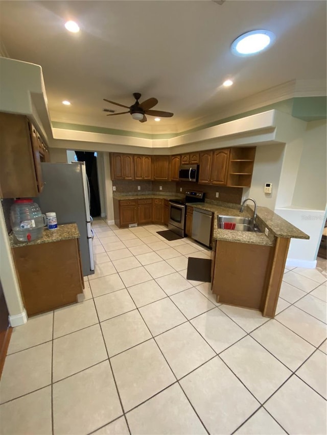 5323 SW 111th Lane Rd, Ocala, FL 34476 - kitchen featuring appliances with stainless steel finishes, a raised ceiling, a sink, a ceiling fan, and open shelves