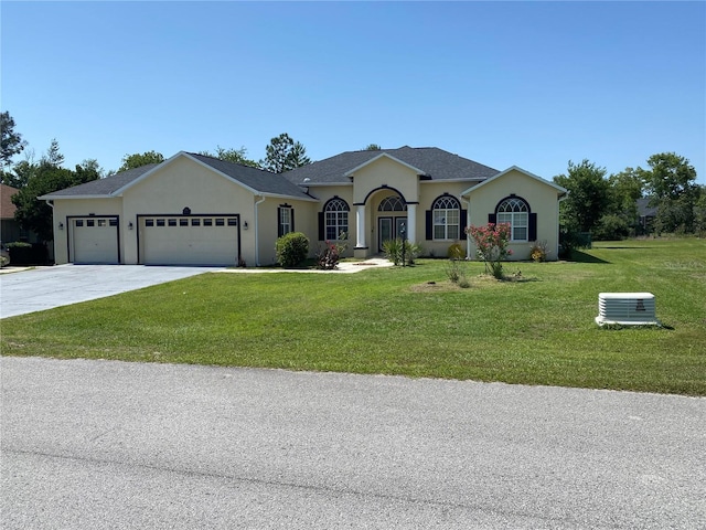5323 SW 111th Lane Rd, Ocala, FL 34476 - ranch-style house with a garage, a front lawn, concrete driveway, and stucco siding