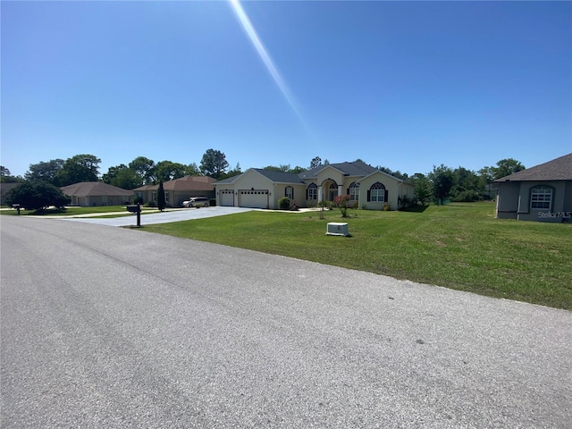 5323 SW 111th Lane Rd, Ocala, FL 34476 - ranch-style home with driveway, a garage, and a front lawn