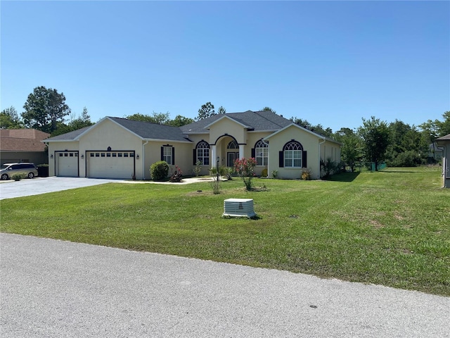 5323 SW 111th Lane Rd, Ocala, FL 34476 - ranch-style house with an attached garage, driveway, stucco siding, and a front lawn