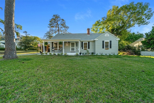 view of front of house featuring a chimney and roof with shingles