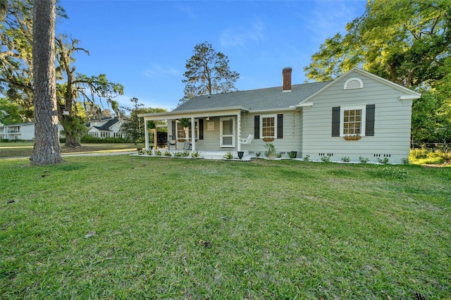 single story home with a front lawn, a chimney, a porch, and a shingled roof