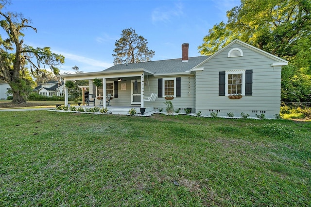single story home with ceiling fan, a chimney, a front yard, and a porch