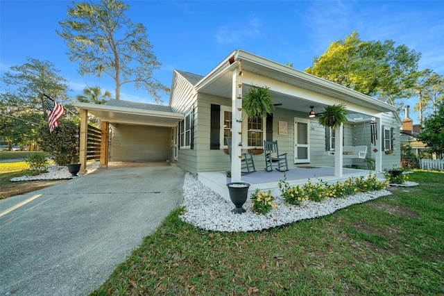 view of front of home featuring concrete driveway, a porch, and a carport