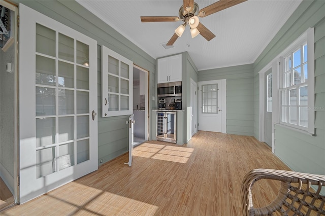 unfurnished sunroom with wine cooler