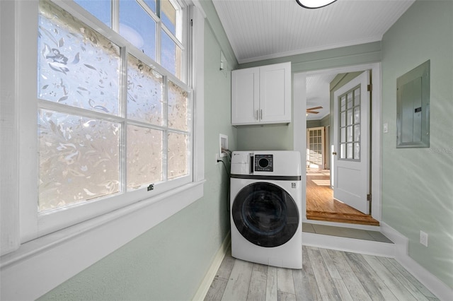 laundry area with washer / dryer, electric panel, cabinet space, baseboards, and light wood finished floors