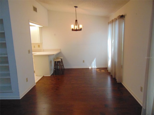 2046 SE 37th Court Cir, Ocala, FL 34471 - unfurnished dining area with an inviting chandelier, dark wood finished floors, vaulted ceiling, visible vents, and baseboards
