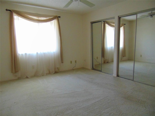 2046 SE 37th Court Cir, Ocala, FL 34471 - unfurnished bedroom featuring ceiling fan, multiple closets, and carpet floors