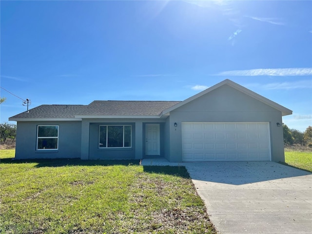 5 Malauka Radial Trak, Ocklawaha, FL 32179 - single story home featuring a garage, stucco siding, a front yard, roof with shingles, and driveway