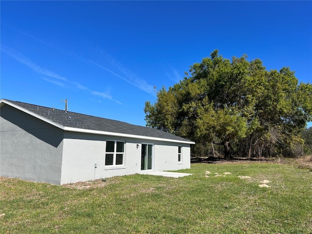 5 Malauka Radial Trak, Ocklawaha, FL 32179 - rear view of property with stucco siding and a lawn