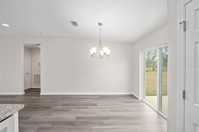 5 Malauka Radial Trak, Ocklawaha, FL 32179 - unfurnished dining area with baseboards, visible vents, a notable chandelier, and wood finished floors