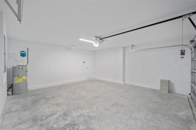 5 Malauka Radial Trak, Ocklawaha, FL 32179 - garage featuring a garage door opener, electric water heater, and concrete block wall