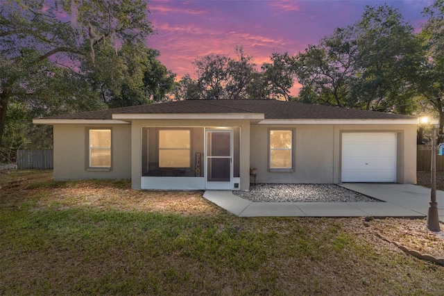 5855 SE 158th Ct, Ocklawaha, FL 32179 - view of front of home featuring concrete driveway, stucco siding, a sunroom, a front yard, and a garage