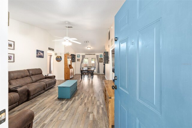 5855 SE 158th Ct, Ocklawaha, FL 32179 - living room with visible vents, a ceiling fan, vaulted ceiling, and light wood-style floors