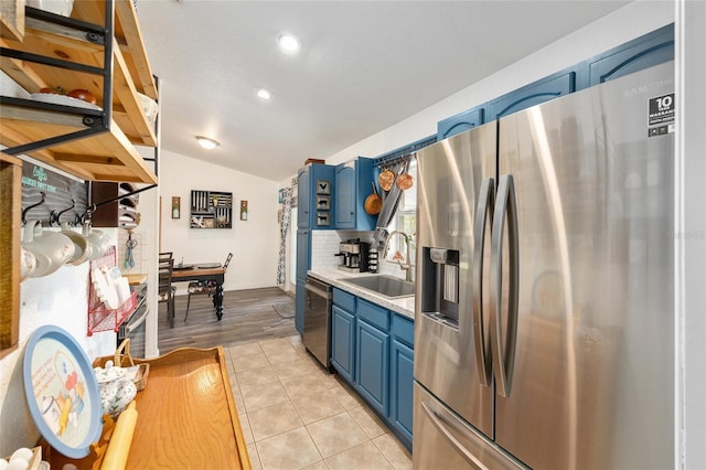 5855 SE 158th Ct, Ocklawaha, FL 32179 - kitchen featuring blue cabinets, a sink, lofted ceiling, light countertops, and appliances with stainless steel finishes