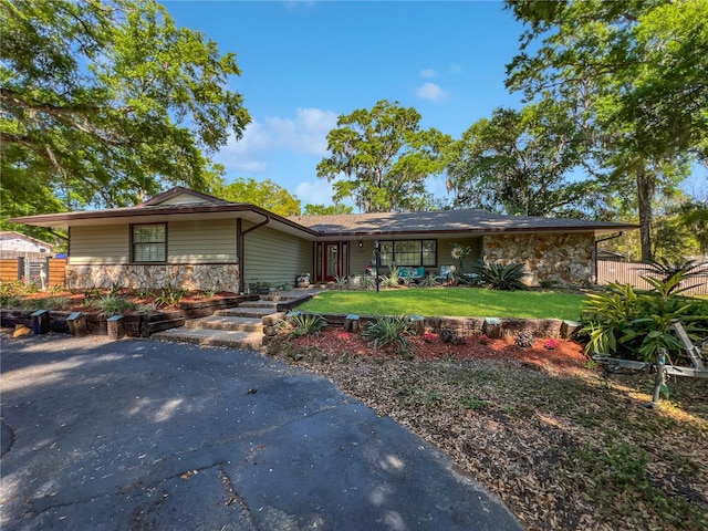 4085 SE 23rd Ter, Ocala, FL 34480 - view of front facade featuring stone siding and a front lawn