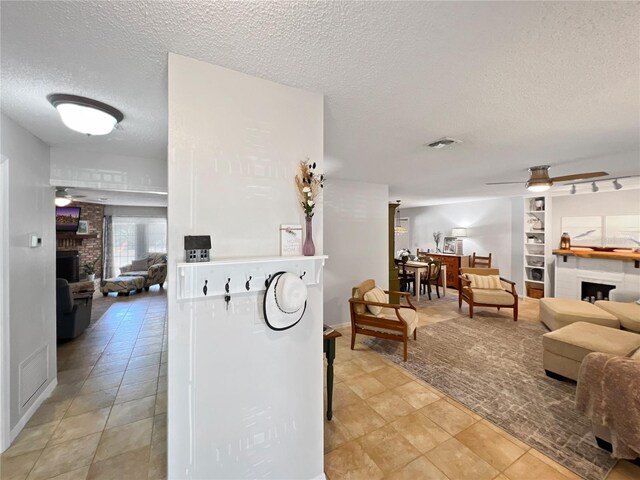 4085 SE 23rd Ter, Ocala, FL 34480 - hall featuring a textured ceiling, built in shelves, and light tile patterned floors