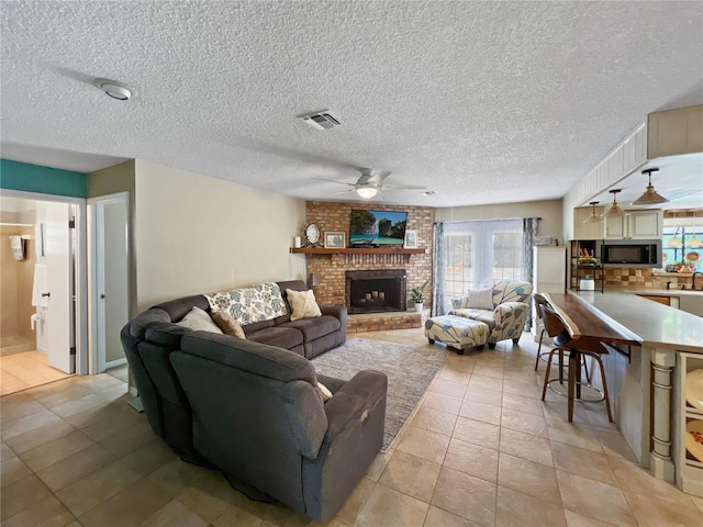 4085 SE 23rd Ter, Ocala, FL 34480 - living area with ceiling fan, a fireplace, light tile patterned floors, and a textured ceiling