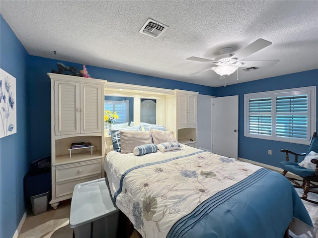 4085 SE 23rd Ter, Ocala, FL 34480 - bedroom featuring multiple windows, a textured ceiling, and a ceiling fan