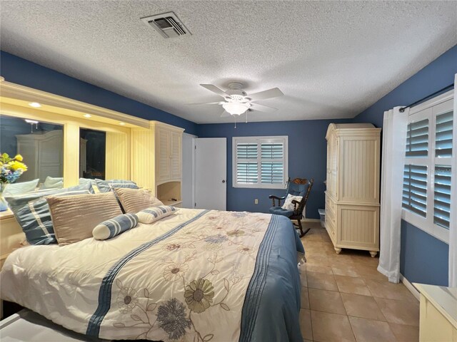 4085 SE 23rd Ter, Ocala, FL 34480 - bedroom with a textured ceiling, light tile patterned flooring, and ceiling fan