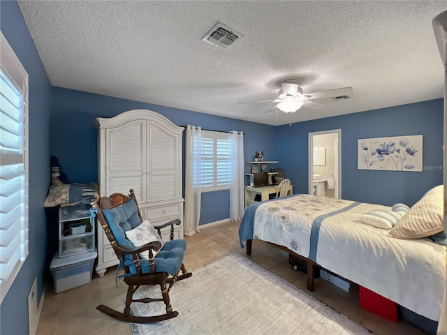 4085 SE 23rd Ter, Ocala, FL 34480 - bedroom with a textured ceiling, tile patterned floors, a ceiling fan, and ensuite bathroom