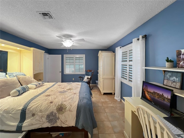 4085 SE 23rd Ter, Ocala, FL 34480 - bedroom featuring a textured ceiling, tile patterned flooring, and a ceiling fan