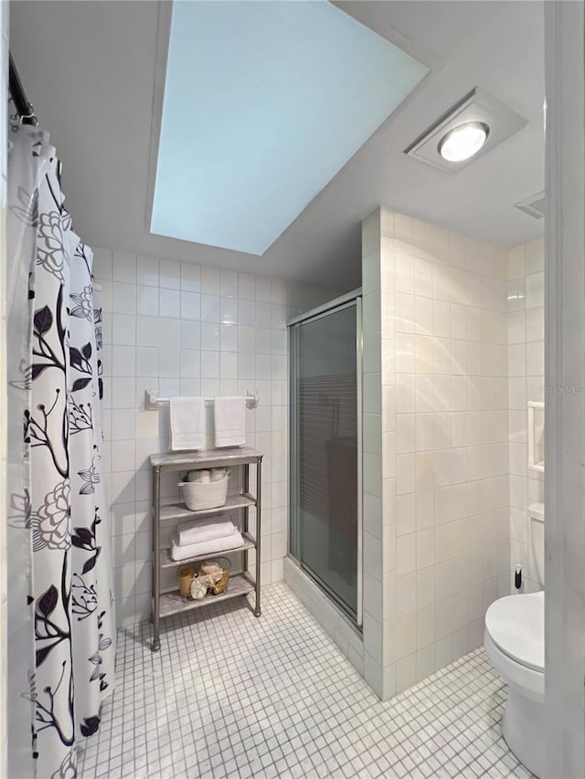 4085 SE 23rd Ter, Ocala, FL 34480 - bathroom featuring tile walls, a stall shower, and tile patterned floors