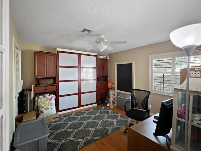 4085 SE 23rd Ter, Ocala, FL 34480 - office with a ceiling fan, dark wood-type flooring, and a textured ceiling