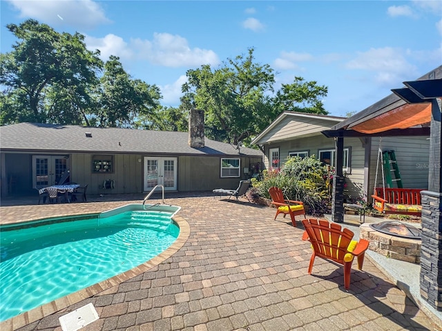 4085 SE 23rd Ter, Ocala, FL 34480 - outdoor pool with french doors, a fire pit, and a patio area