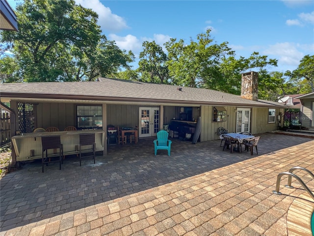 4085 SE 23rd Ter, Ocala, FL 34480 - rear view of house featuring french doors, board and batten siding, and a patio area
