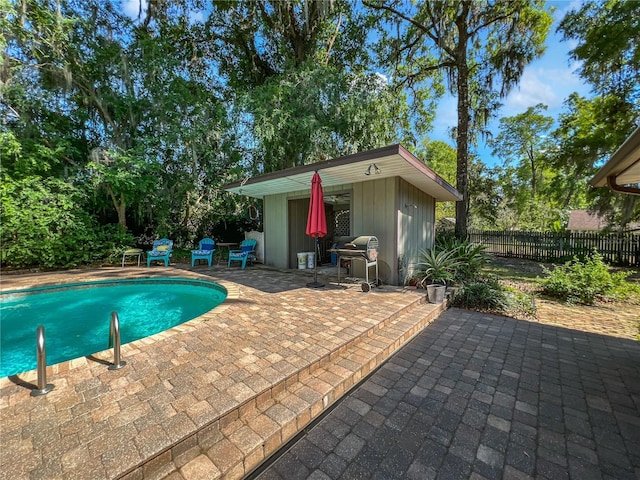 4085 SE 23rd Ter, Ocala, FL 34480 - view of swimming pool featuring an outdoor structure, a patio area, grilling area, and an exterior structure