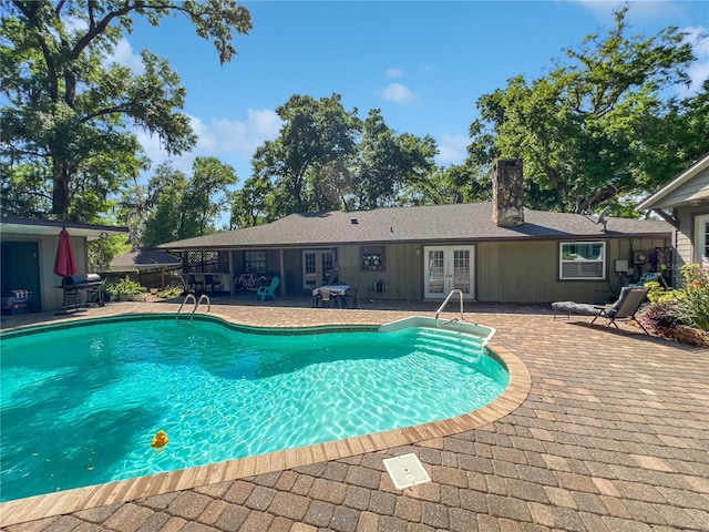 4085 SE 23rd Ter, Ocala, FL 34480 - swimming pool with french doors, a patio area, and grilling area
