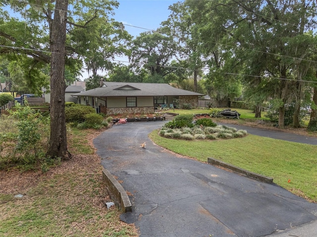 4085 SE 23rd Ter, Ocala, FL 34480 - view of front of house featuring driveway, a front lawn, and stone siding