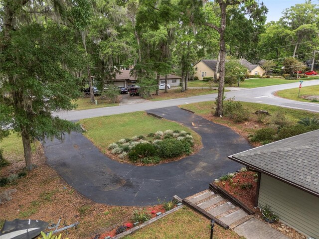 4085 SE 23rd Ter, Ocala, FL 34480 - view of community featuring curved driveway and a lawn