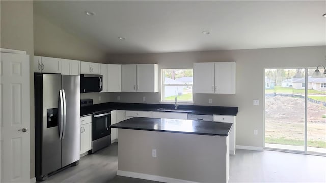 17654 SW 112th Ln, Dunnellon, FL 34432 - kitchen with white cabinets, dark countertops, stainless steel appliances, and a sink